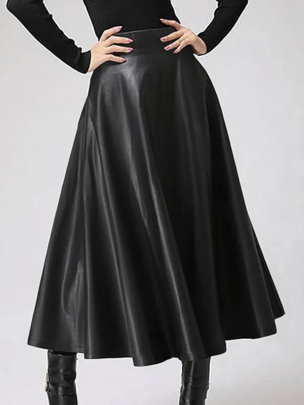femme avec les mains sur les hanches portant une jupe longue évasée en simili cir noire taille haute
